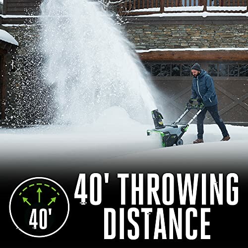 Man using snow blower with 40-foot throwing distance